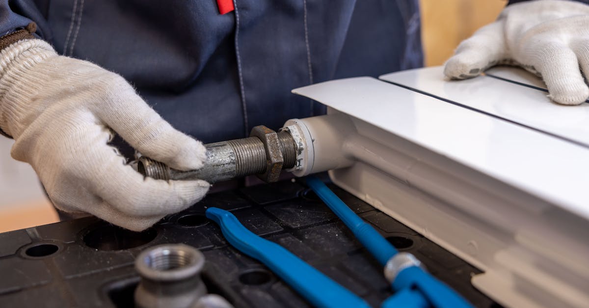 close up of a plumber installing a radiator pipe using specialized tools