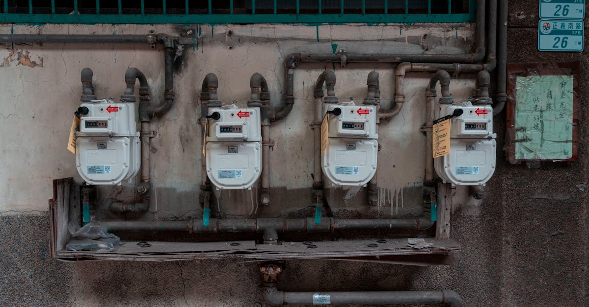 four gas meters mounted on an exterior wall showcasing urban utility infrastructure